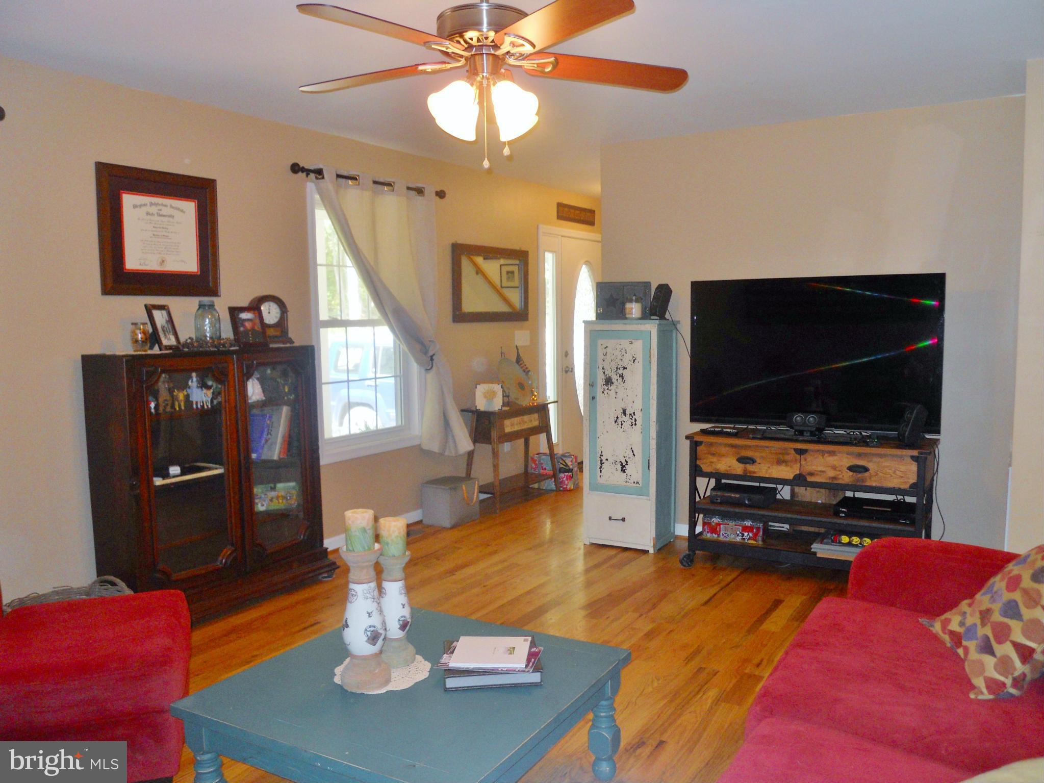 244 Fairview Church Road Gore, VA 22637 - Photo 18 of 30 a living room with furniture and a flat screen tv