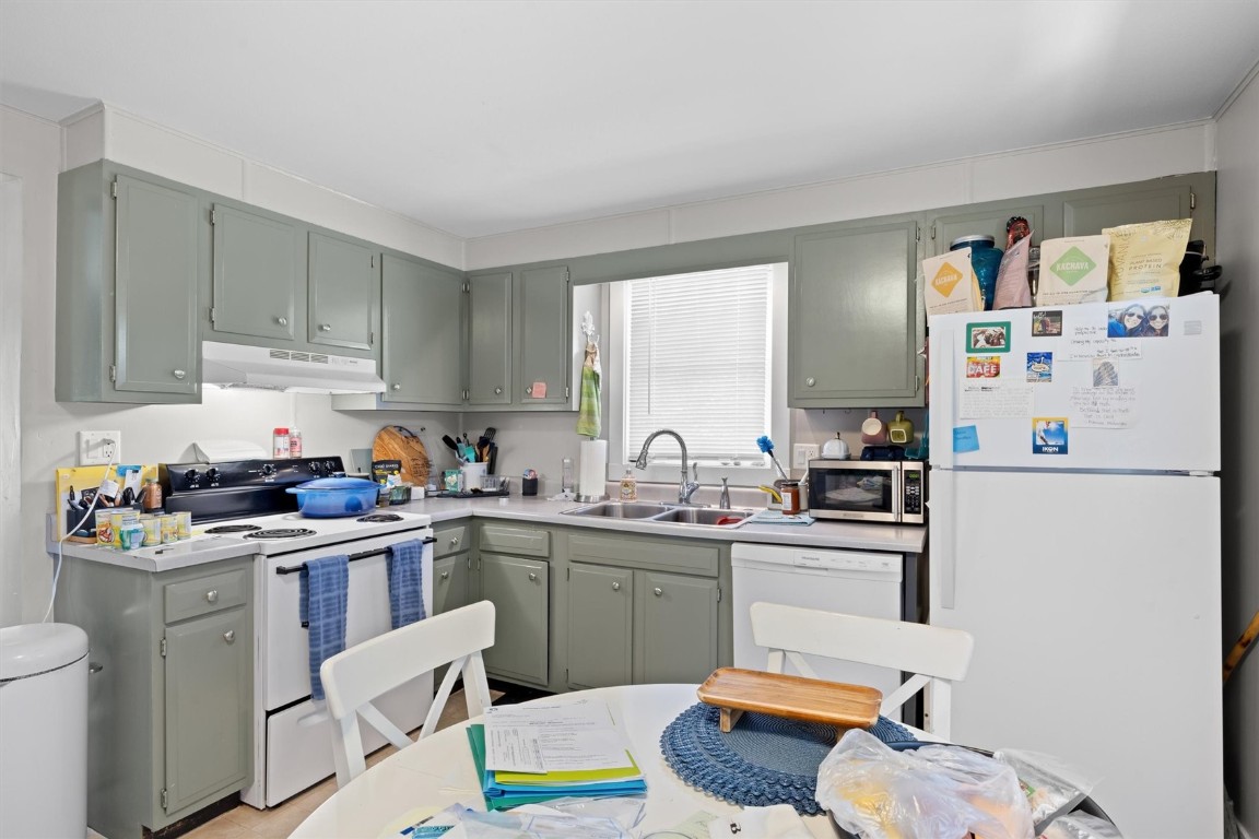 2646 Riverside Drive, Unit A Steamboat Springs, CO 80487 - Photo 3 of 12 a kitchen with a sink a stove a refrigerator and cabinets