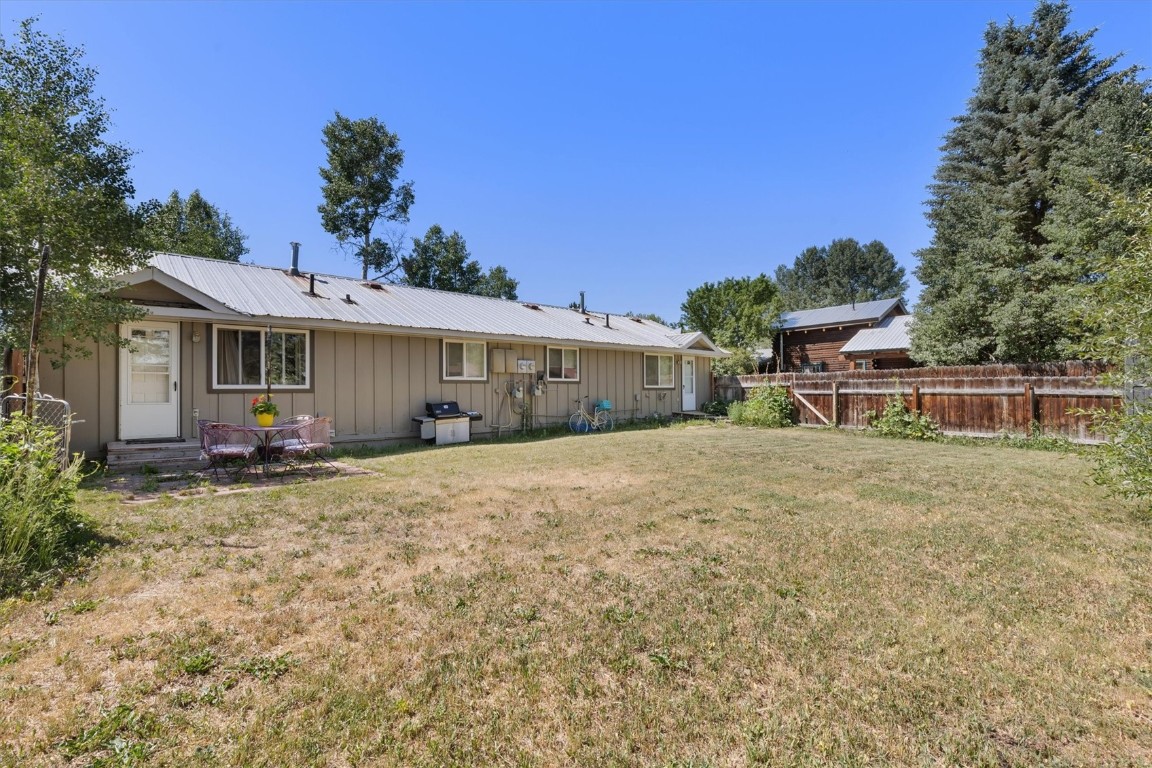 2646 Riverside Drive, Unit A Steamboat Springs, CO 80487 - Photo 10 of 12 a front view of a house with a yard and potted plants