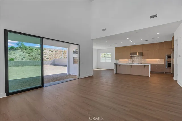 a view of a kitchen with a sink and a large window