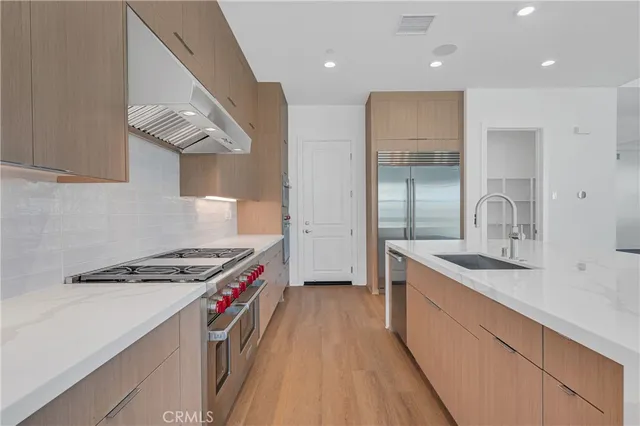 a kitchen with stainless steel appliances granite countertop a sink and a stove