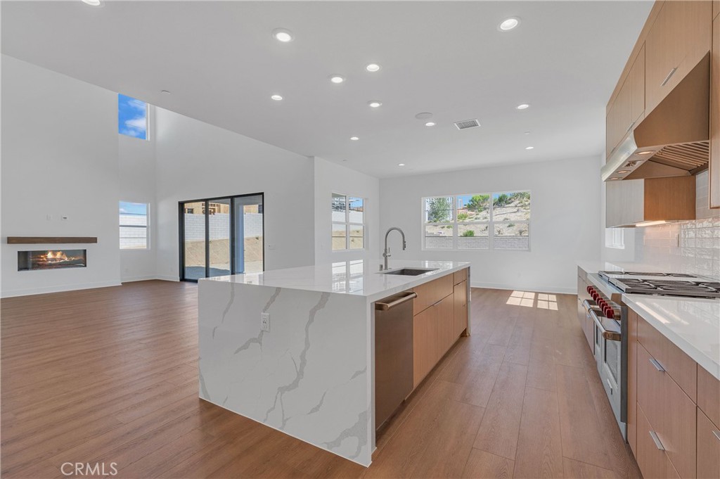 27510 Elderberry Drive Valencia, CA 91381 - Photo 20 of 60 a large kitchen with stainless steel appliances granite countertop a lot of counter space and wooden floor