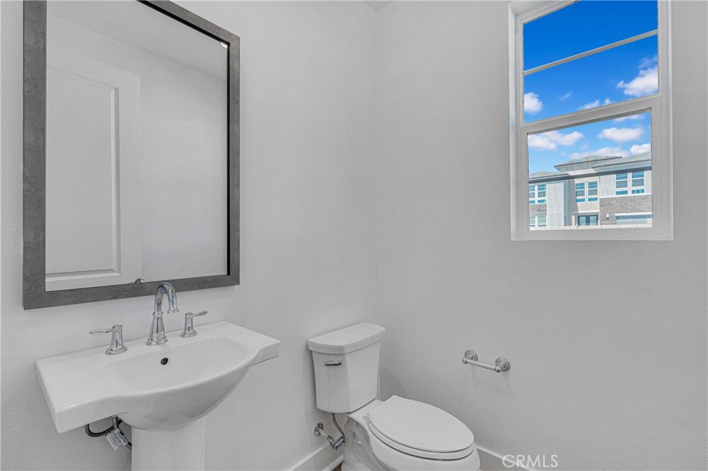 27510 Elderberry Drive Valencia, CA 91381 - Photo 27 of 60 a bathroom with a sink a toilet and mirror