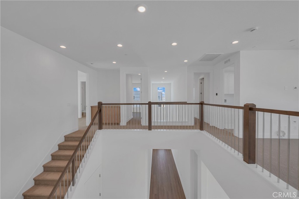 27510 Elderberry Drive Valencia, CA 91381 - Photo 31 of 60 a view of a hallway with wooden floor leading to a staircase
