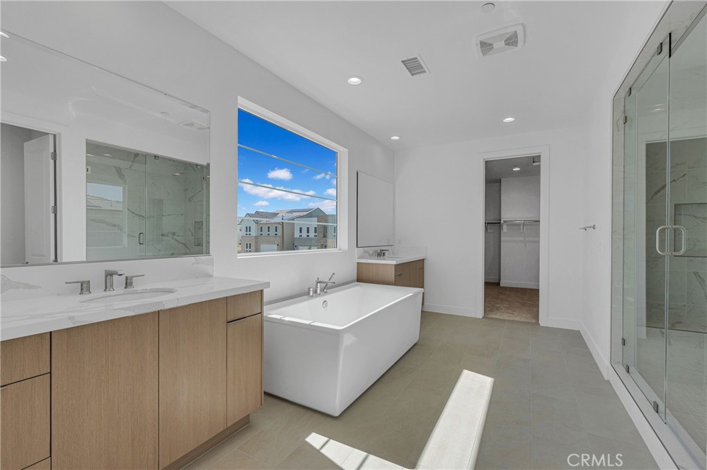 27510 Elderberry Drive Valencia, CA 91381 - Photo 38 of 60 a spacious bathroom with a tub sink and mirror