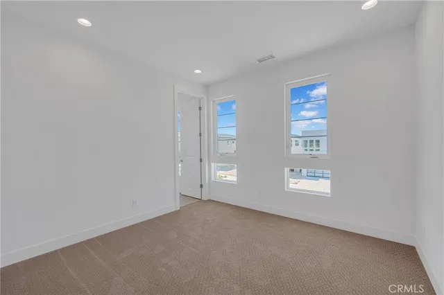 a view of a room with cabinet and a ceiling fan