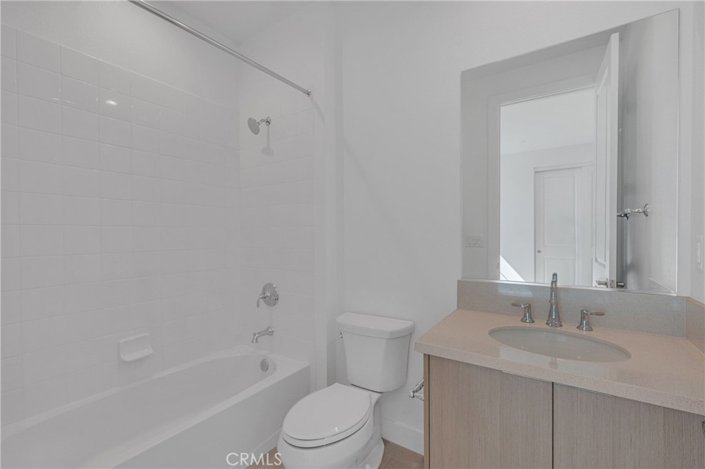 27510 Elderberry Drive Valencia, CA 91381 - Photo 47 of 60 a bathroom with a toilet a sink a mirror and a bathtub