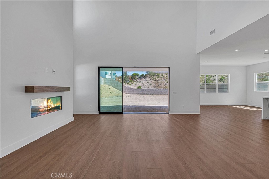 27510 Elderberry Drive Valencia, CA 91381 - Photo 8 of 60 a view of an empty room with a window and wooden floor