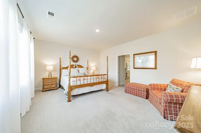 a bedroom with furniture and a lamp