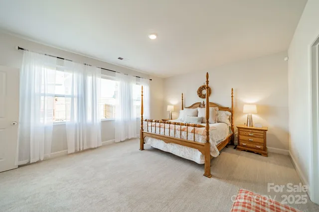 a spacious bedroom with a bed and a window