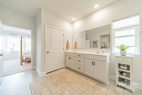 a spacious bathroom with a granite countertop sink and a mirror