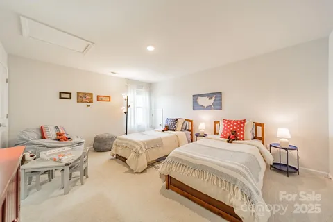 a spacious bedroom with two beds and a table