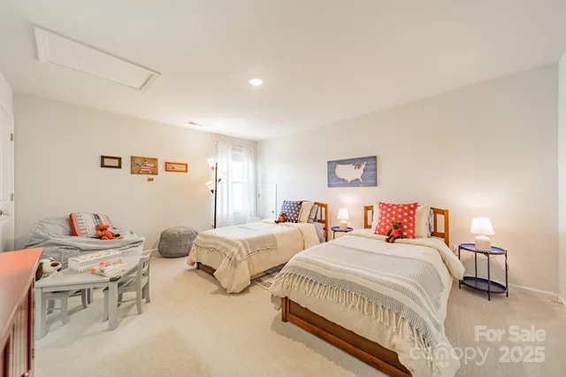 a spacious bedroom with two beds and a table