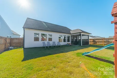 a view of a house with a yard and swimming pool