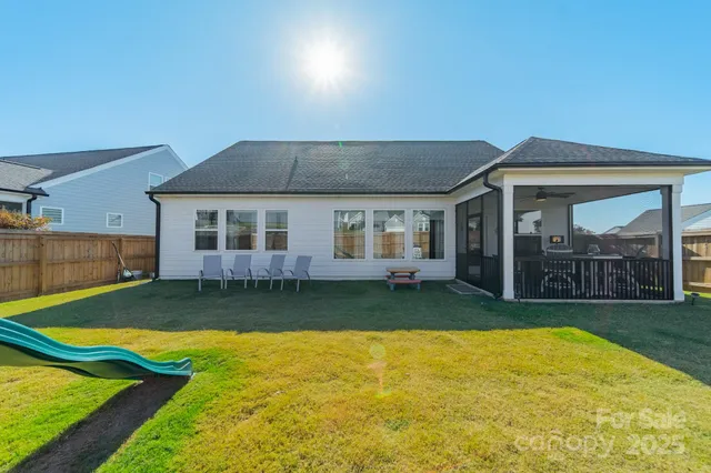 a view of a house with swimming pool and yard