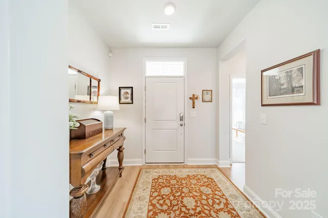 a view of room with furniture and wooden floor