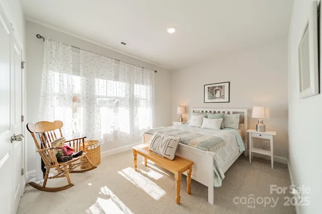 a spacious bedroom with a bed and a chair