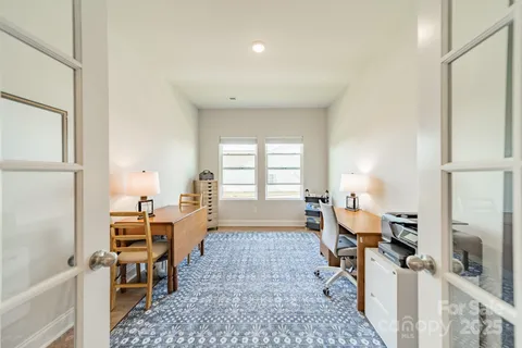 a living room with furniture a large window and a rug