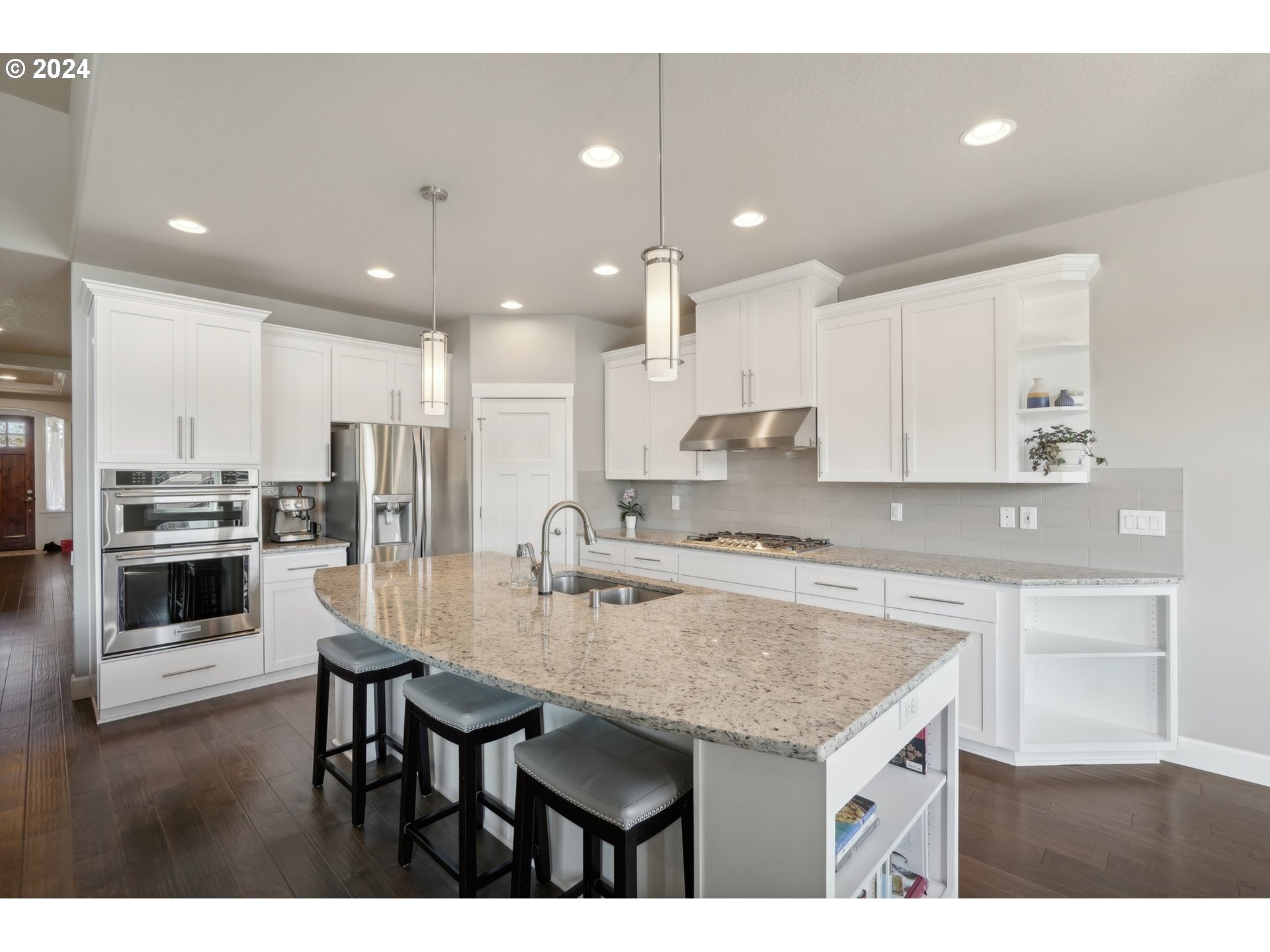 1701 South Nighthawk Road Ridgefield, WA 98642 - Photo 16 of 45 a kitchen with kitchen island granite countertop a sink and stove