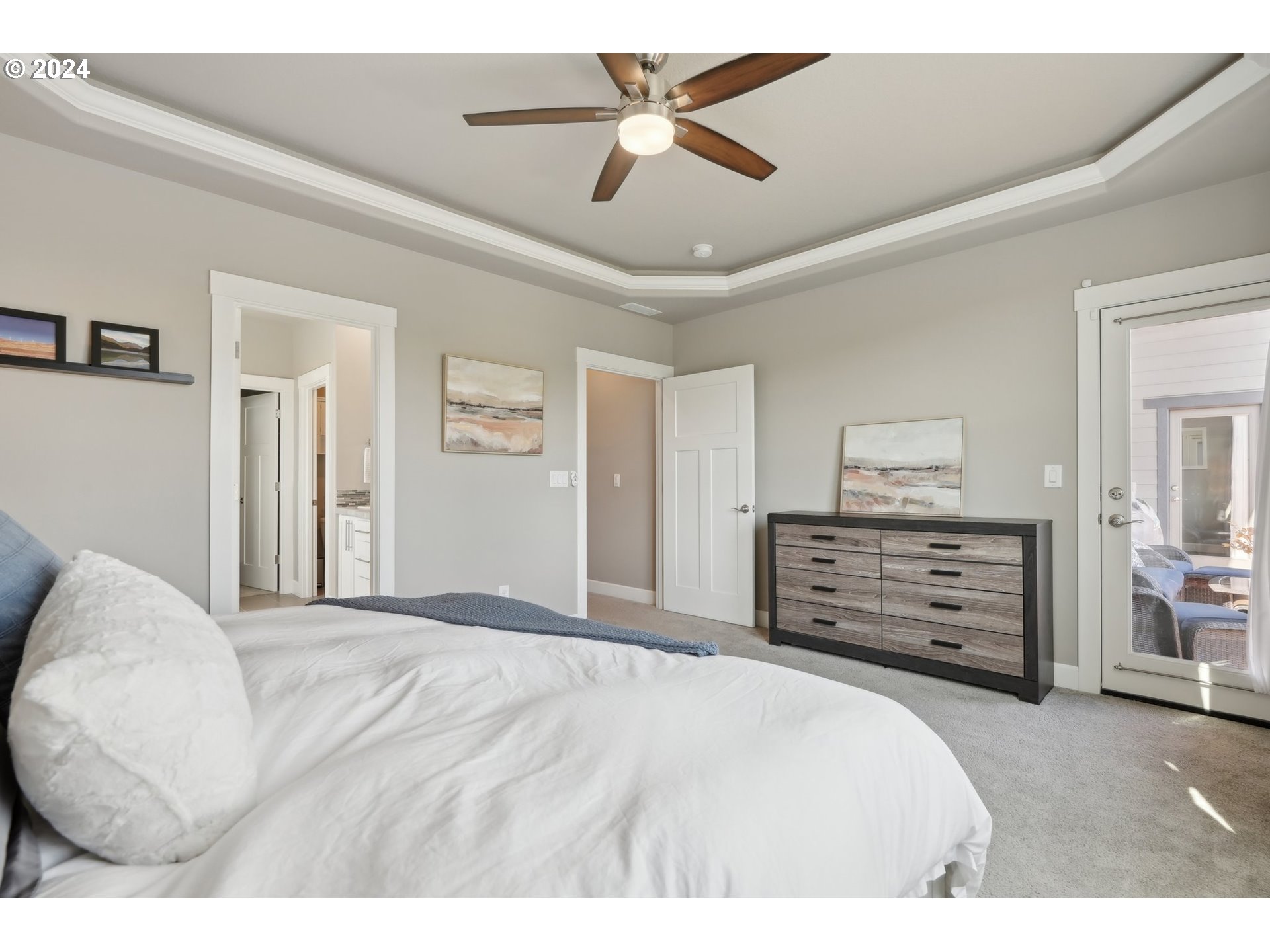 1701 South Nighthawk Road Ridgefield, WA 98642 - Photo 26 of 45 a bedroom with a bed a dresser and a chandelier