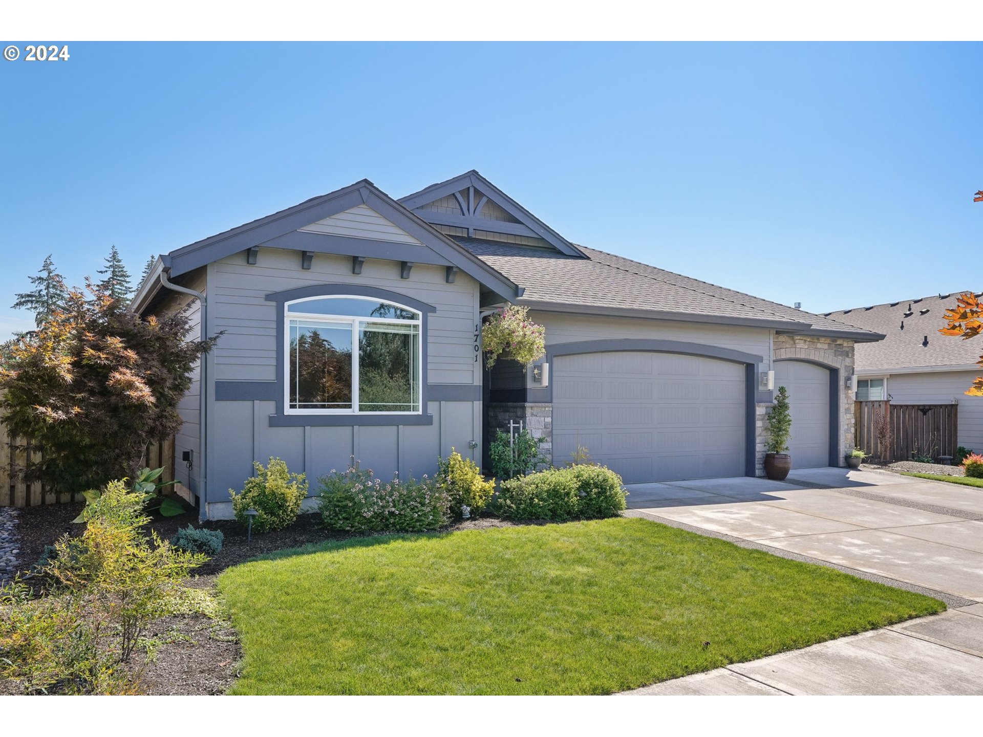 1701 South Nighthawk Road Ridgefield, WA 98642 - Photo 3 of 45 a front view of a house with a yard and garage