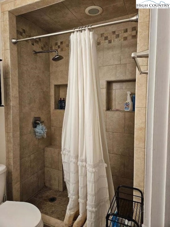 116 Grand Boulevard, Unit 1M Boone, NC 28607 - Photo 12 of 14 a bathroom with a shower and a toilet