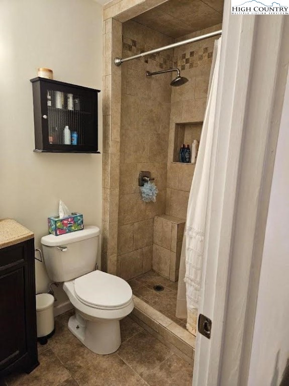 116 Grand Boulevard, Unit 1M Boone, NC 28607 - Photo 14 of 14 a white toilet sitting next to a bathroom sink and a shower