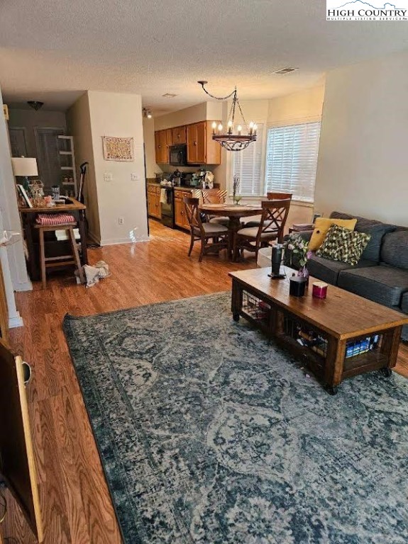 116 Grand Boulevard, Unit 1M Boone, NC 28607 - Photo 3 of 14 a living room with furniture and a flat screen tv