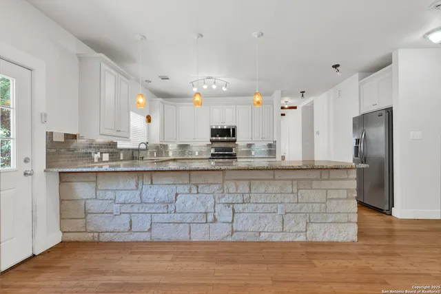 a view of a kitchen with a sink and a window
