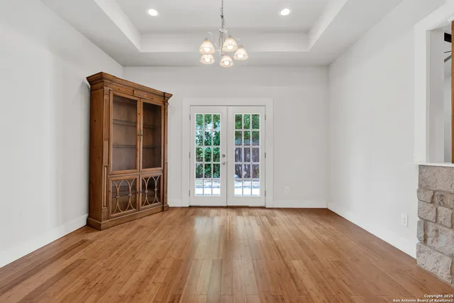 a kitchen with stainless steel appliances granite countertop wooden cabinets granite counter tops and a hard wood floors