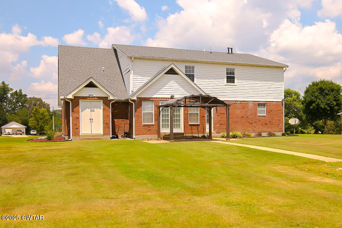 290 Westover Road Huron, TN 38345 - Photo 25 of 26 a front view of a house with a big yard and large trees