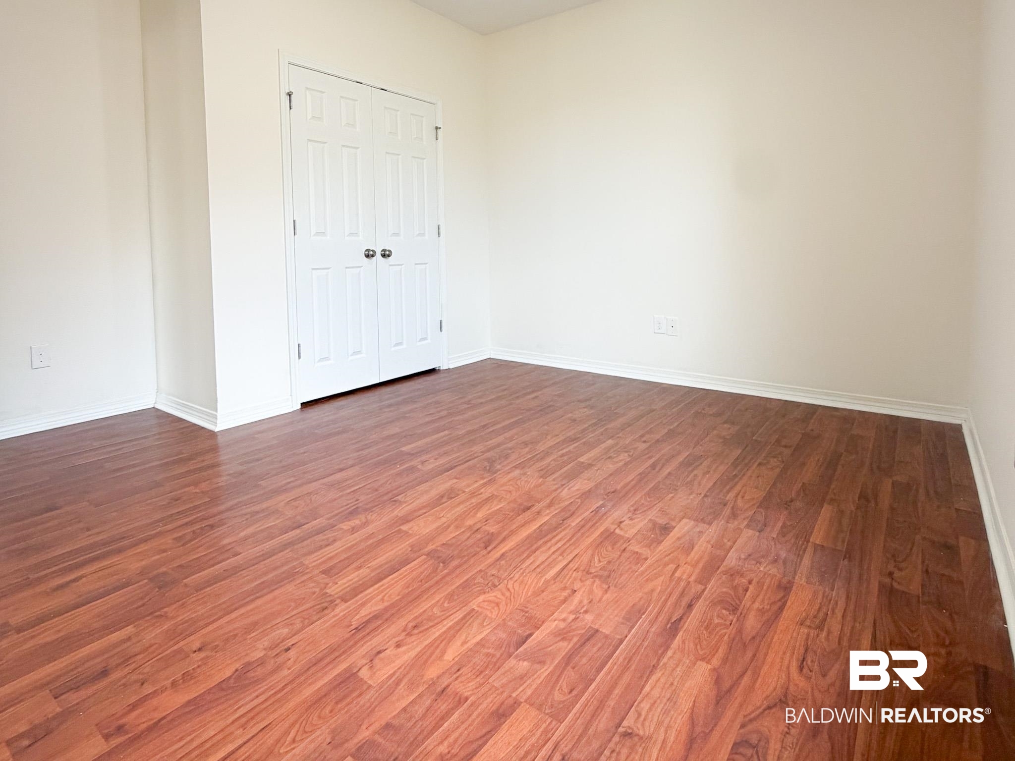 7332 Raintree Lane Gulf Shores, AL 36542 - Photo 15 of 21 Unfurnished bedroom with dark wood finished floors and a closet