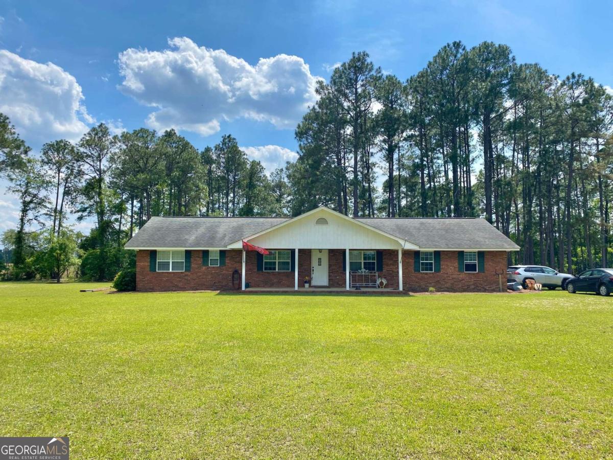 585 Coleman Road Vidalia, GA 30474 - Photo 1 of 1 a view of a house with a yard and sitting area