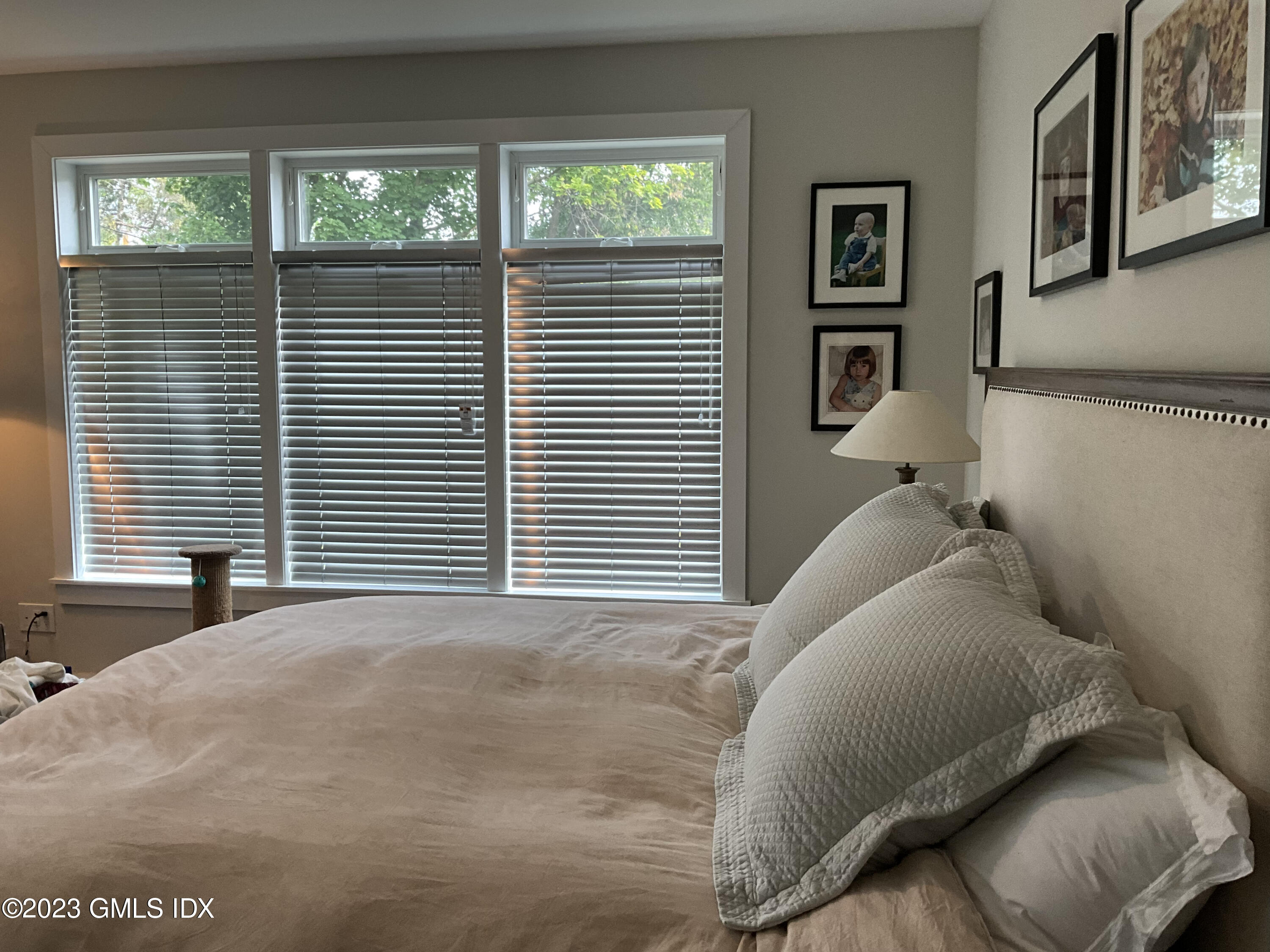 56 Old Field Point Road, Unit 4 Greenwich, CT 06830 - Photo 13 of 32 a bedroom with a bed and a large window