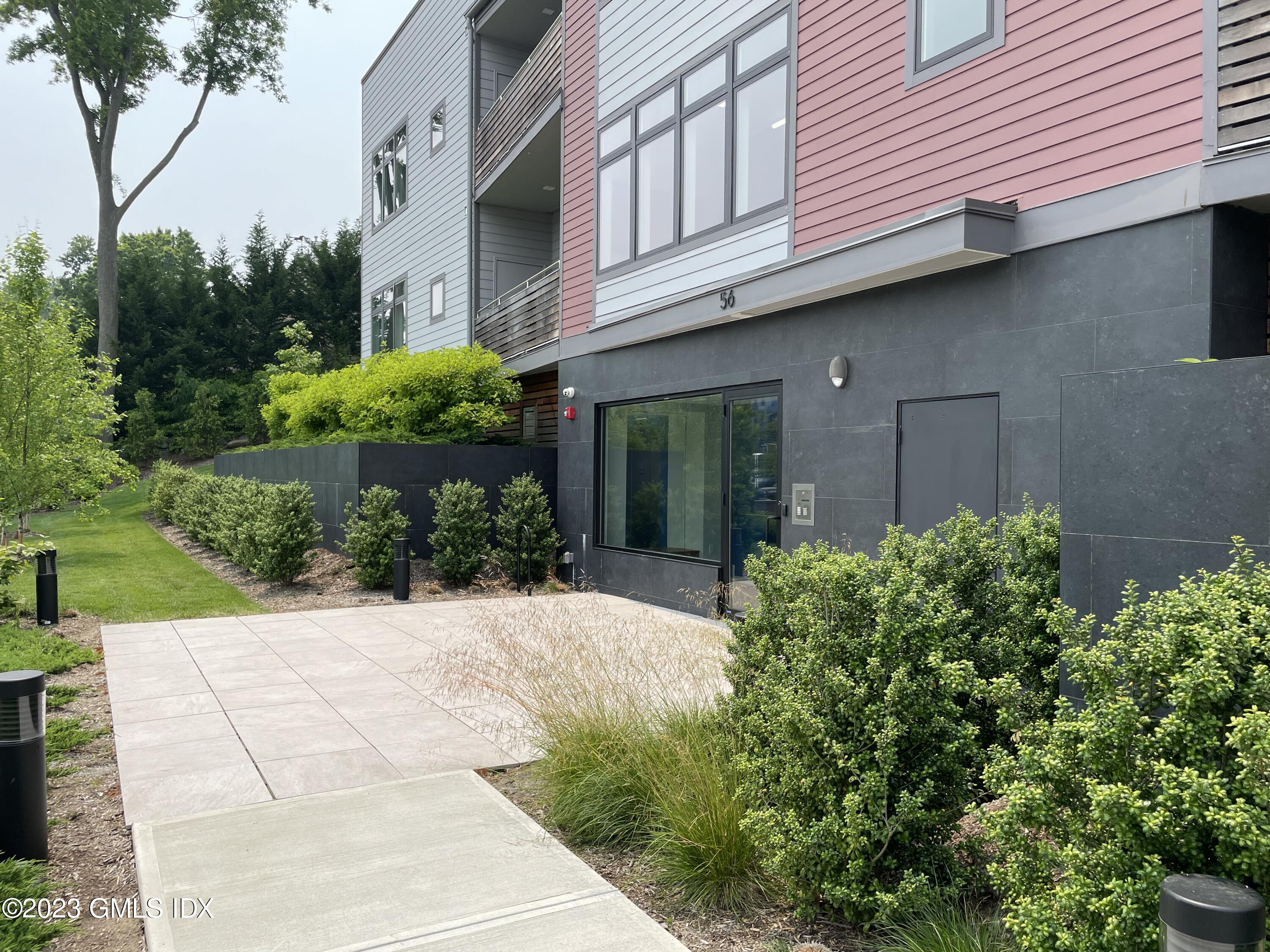 56 Old Field Point Road, Unit 4 Greenwich, CT 06830 - Photo 2 of 32 a view of a house with a yard and plants
