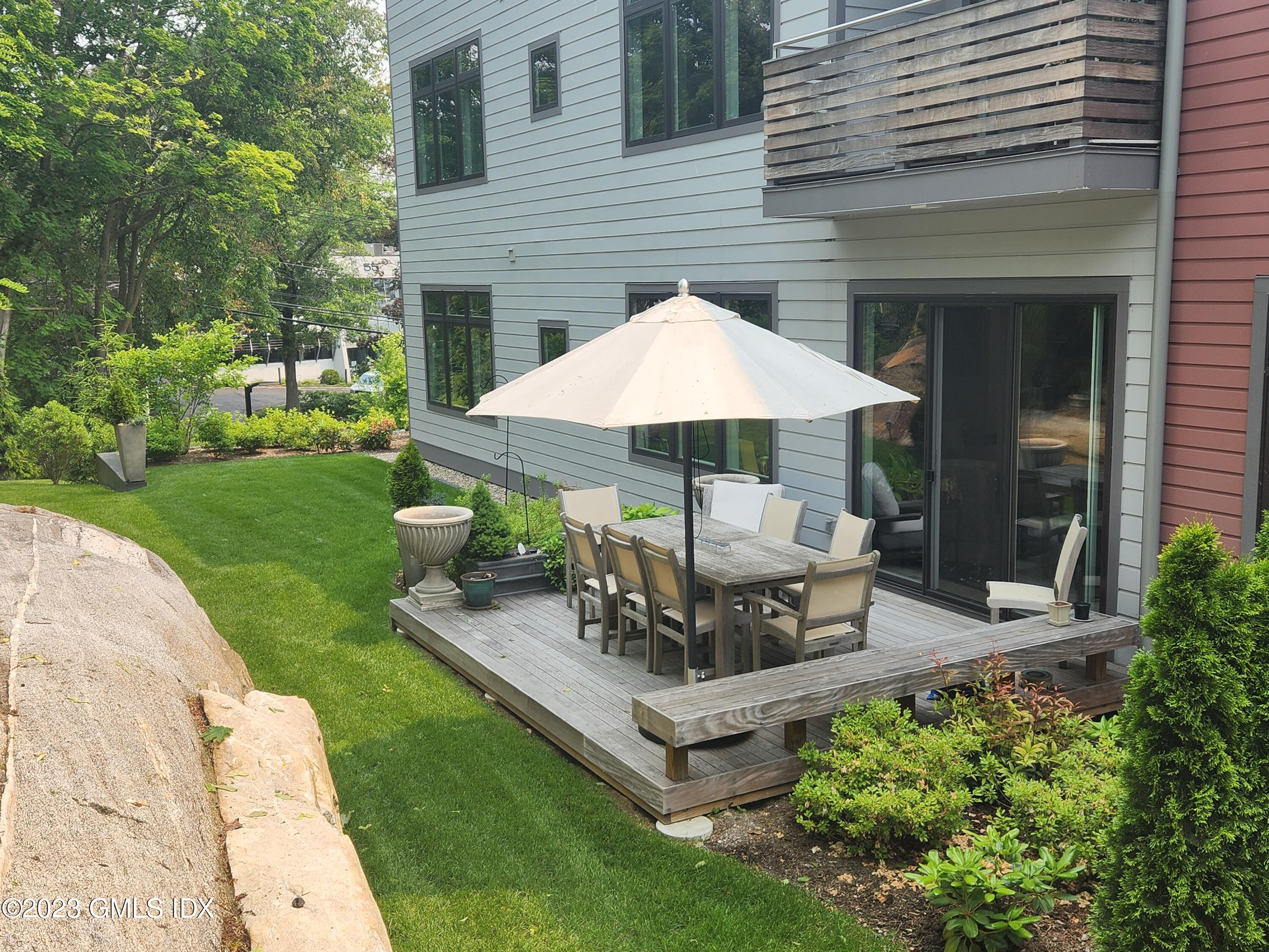 56 Old Field Point Road, Unit 4 Greenwich, CT 06830 - Photo 4 of 32 a view of a house with backyard and sitting area