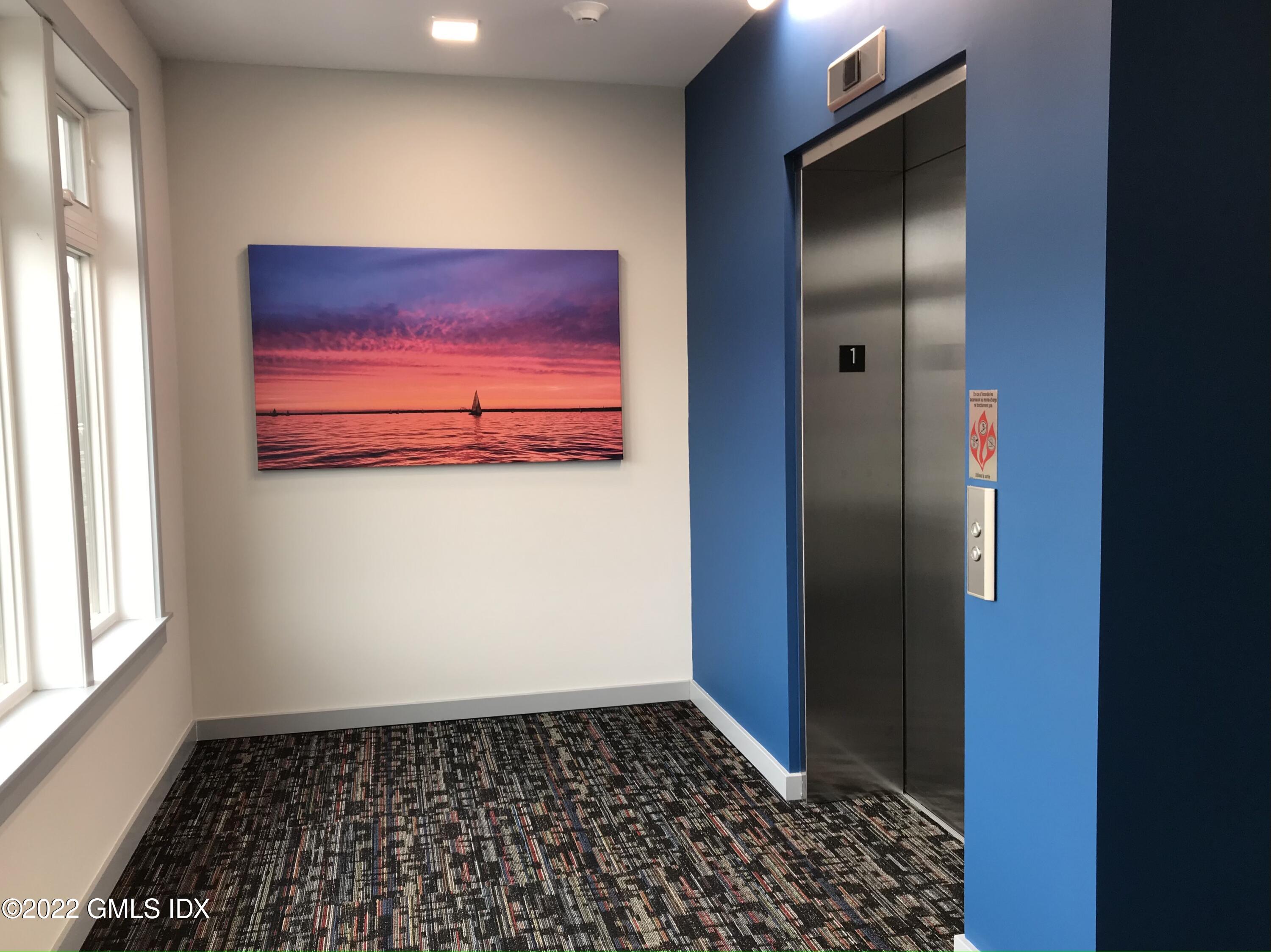 56 Old Field Point Road, Unit 4 Greenwich, CT 06830 - Photo 7 of 32 a bathroom with a glass door shower and a window