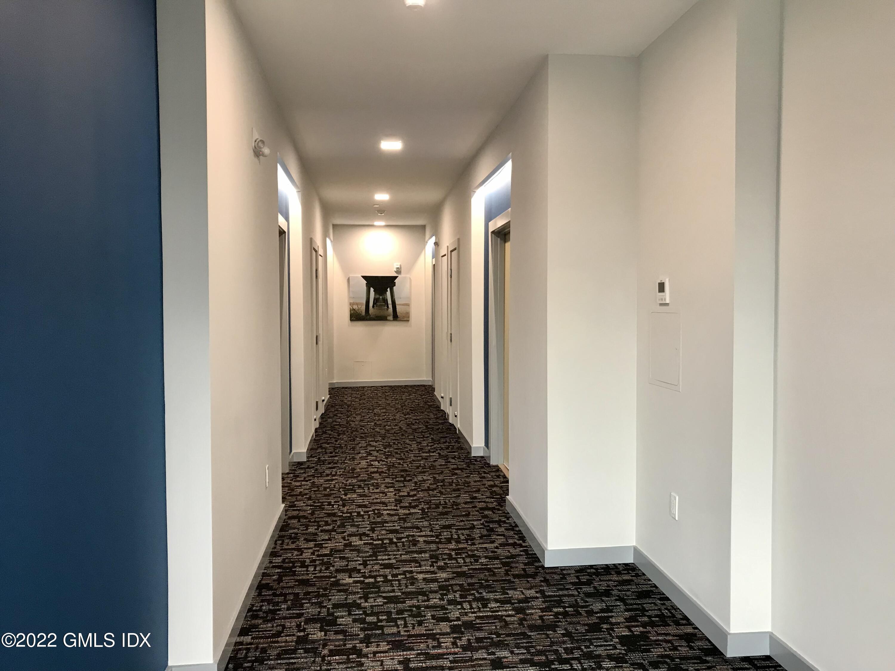 56 Old Field Point Road, Unit 4 Greenwich, CT 06830 - Photo 8 of 32 a view of hallway with wooden floor