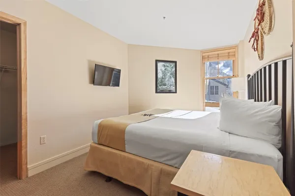 a bedroom with a bed and a flat screen tv