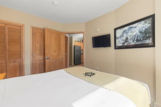 a bedroom with furniture and a large window