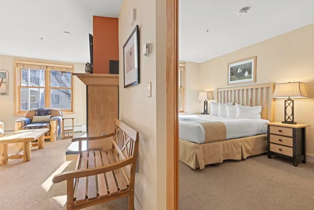 a bedroom with a bed a table and chairs