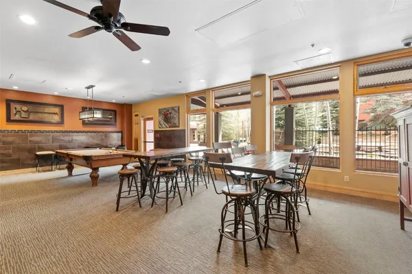 a room with table tennis table and sofas