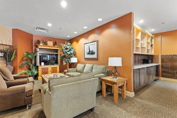 a living room with furniture and a rug