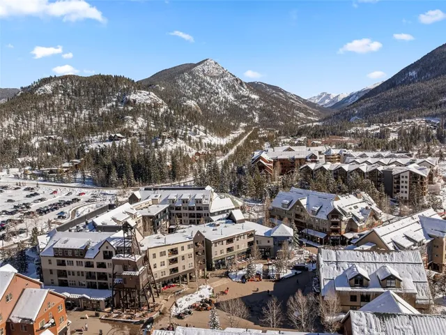 a dining room with furniture and a floor to ceiling window