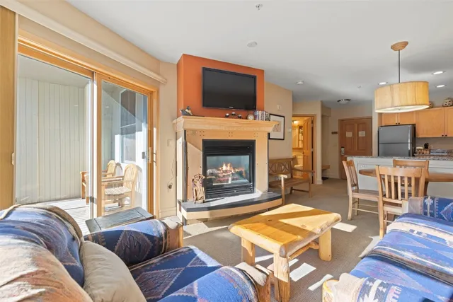 a living room with furniture and kitchen view