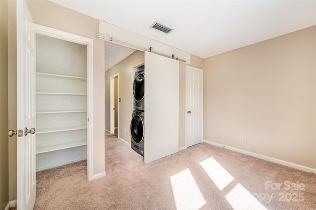 a view of a hallway with washer and dryer