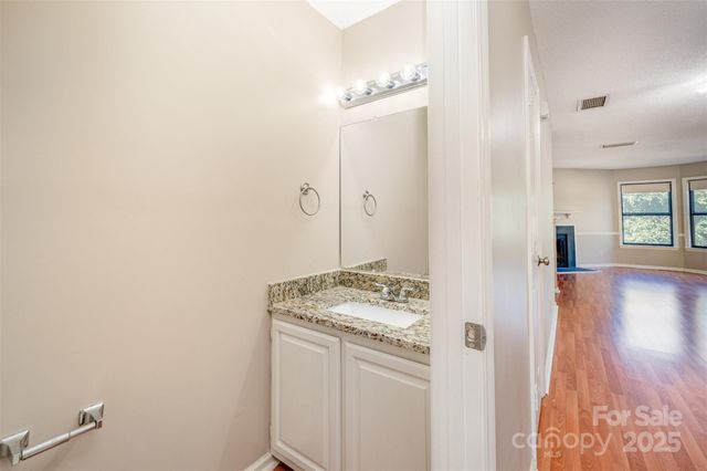a bathroom with a sink a vanity and a mirror