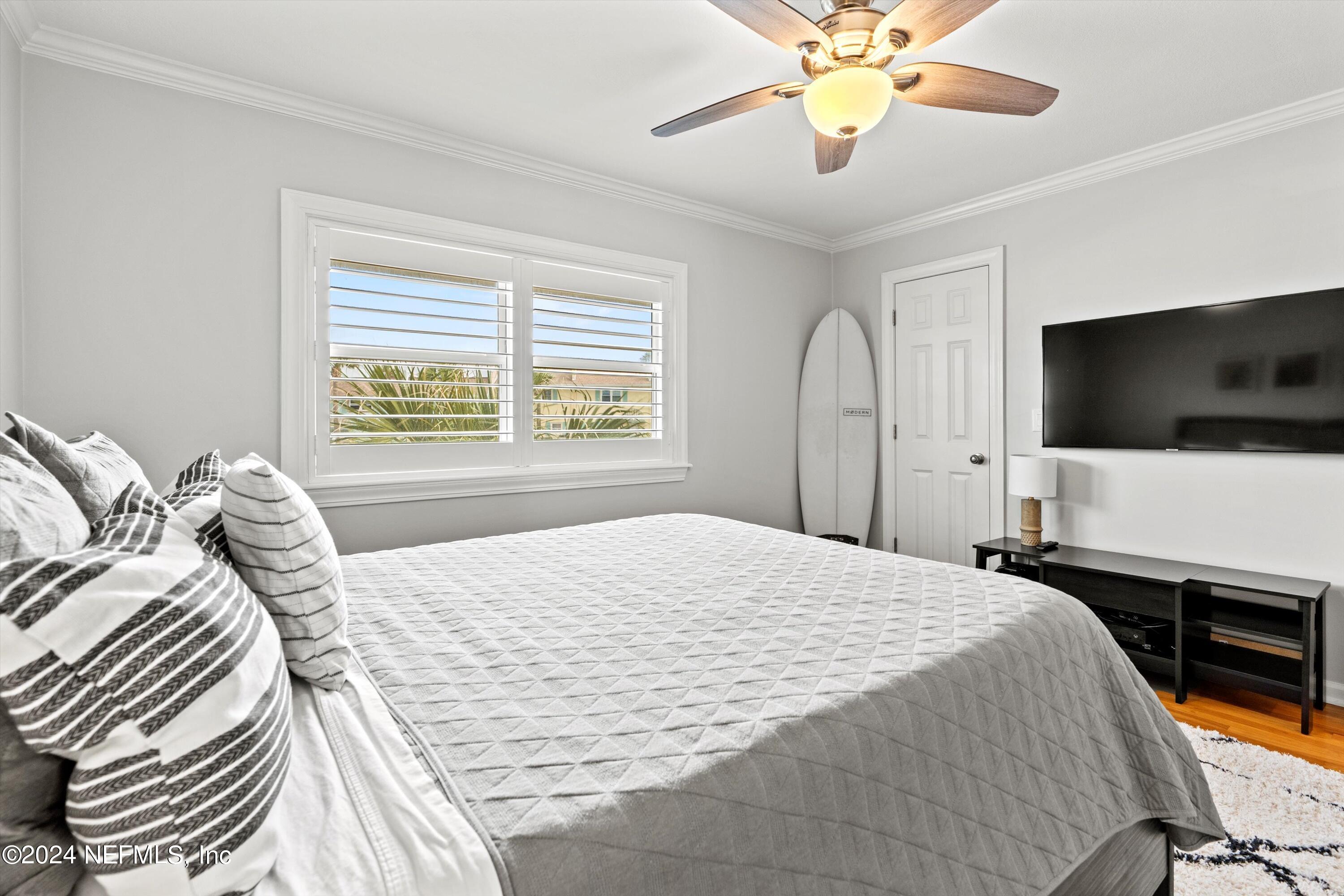 2233 Seminole Road, Unit 31 Atlantic Beach, FL 32233 - Photo 28 of 38 a bedroom with a bed and a flat tv screen on dresser