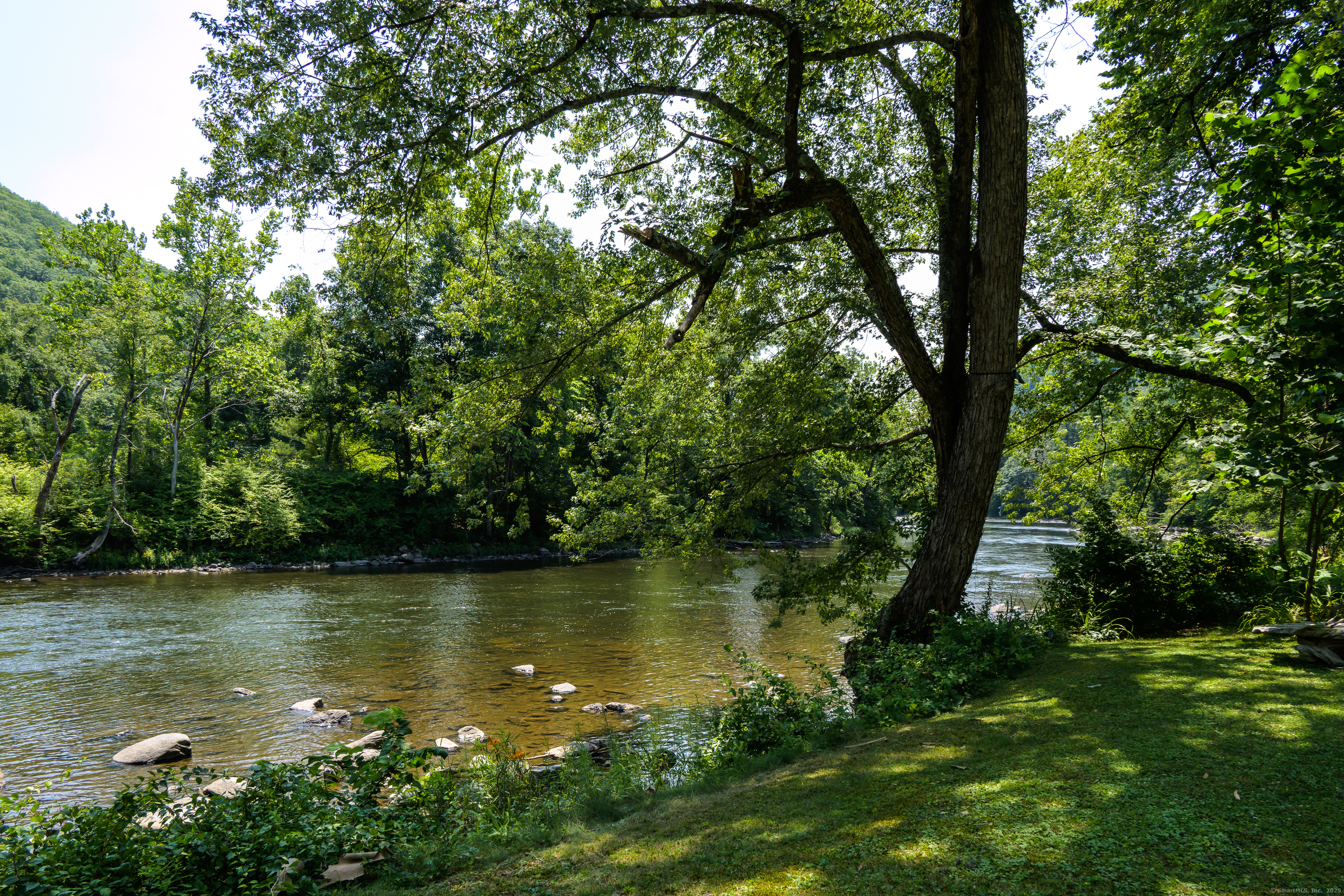 35 Kirk Road Sharon, CT 06796 - Photo 12 of 40 a view of a lake with a yard and large trees