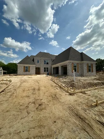 a large house with a large tree in front of it